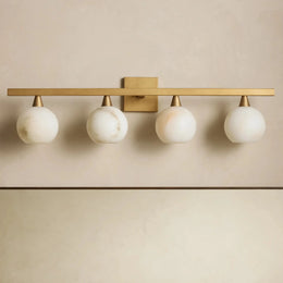 Arica four-light alabaster wall sconce in Antique Brass