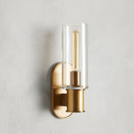 Harrlin clear glass wall sconce in Brass finish